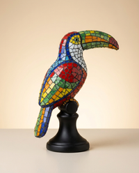 Hand-painted Trencadis mosaic toucan figurine on a black pedestal